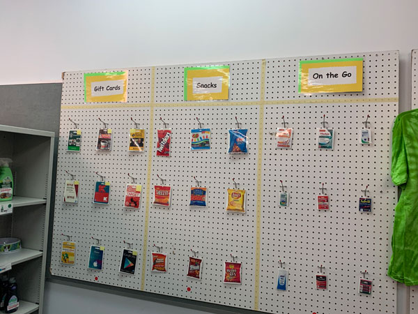 Shelving area for hanging snack packages and gift cards